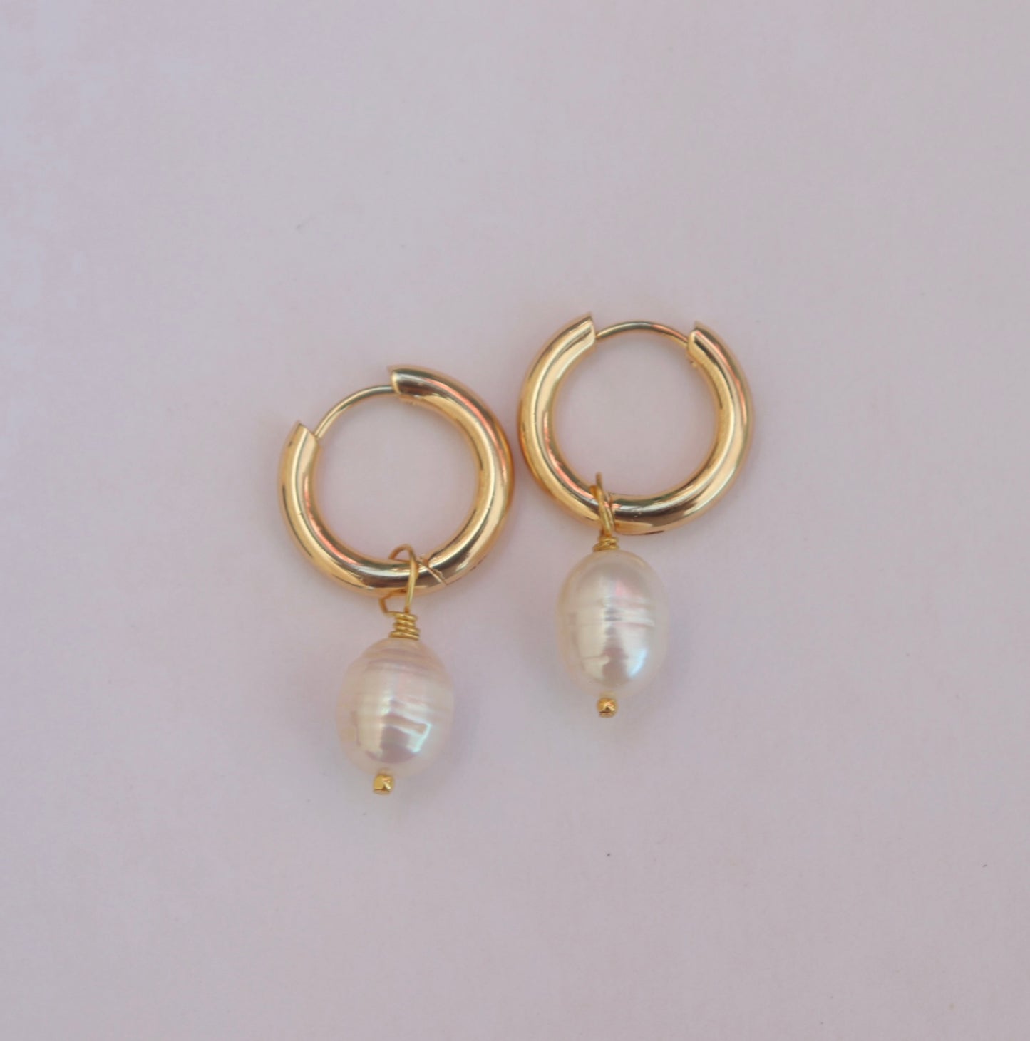 Gold hoop earrings with pearl drops